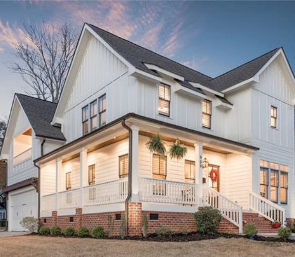 Stunning white farmhouse with wrap around porch in Charlotte, North Carolina.