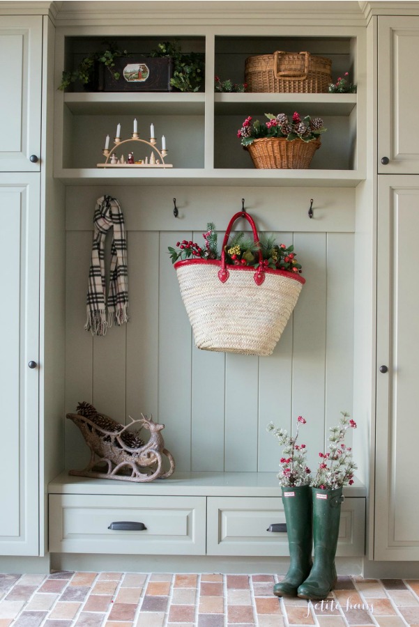 Christmas decor in a beautiful muted green painted woodwork in a custom mud room by Petite Haus.