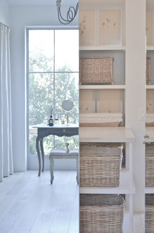 Patina Farm laundry room with rustic french farmhouse baskets, on the wall drying rack, and plaster walls. Design: Giannetti Home and photo via Velvet and Linen.