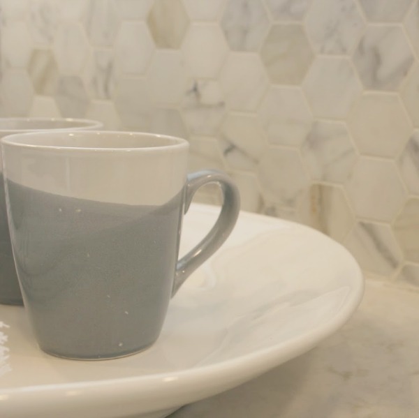 As real life renovators, we made over our ugly Arizona kitchen with no demo or dust with smart upgrades and swaps. Light grey cabinets, Viatera quartz counters (Soprano), and calacatta marble hex accent wall - Hello Lovely studio.