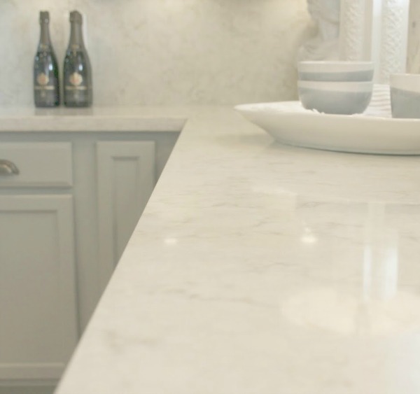 As real life renovators, we made over our ugly Arizona kitchen with no demo or dust with smart upgrades and swaps. Light grey cabinets, Viatera quartz counters (Soprano), and calacatta marble hex accent wall - Hello Lovely studio.