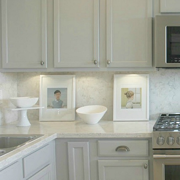 As real life renovators, we made over our ugly Arizona kitchen with no demo or dust with smart upgrades and swaps. Light grey cabinets, Viatera quartz counters (Soprano), and calacatta marble hex accent wall - Hello Lovely studio.