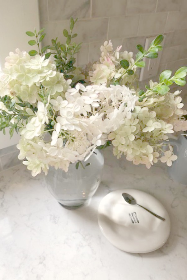 A mix of whites in my timelessly tranquil kitchen with European country decor, Viatera Minuet quartz, and Belgian linen - Hello Lovely Studio.