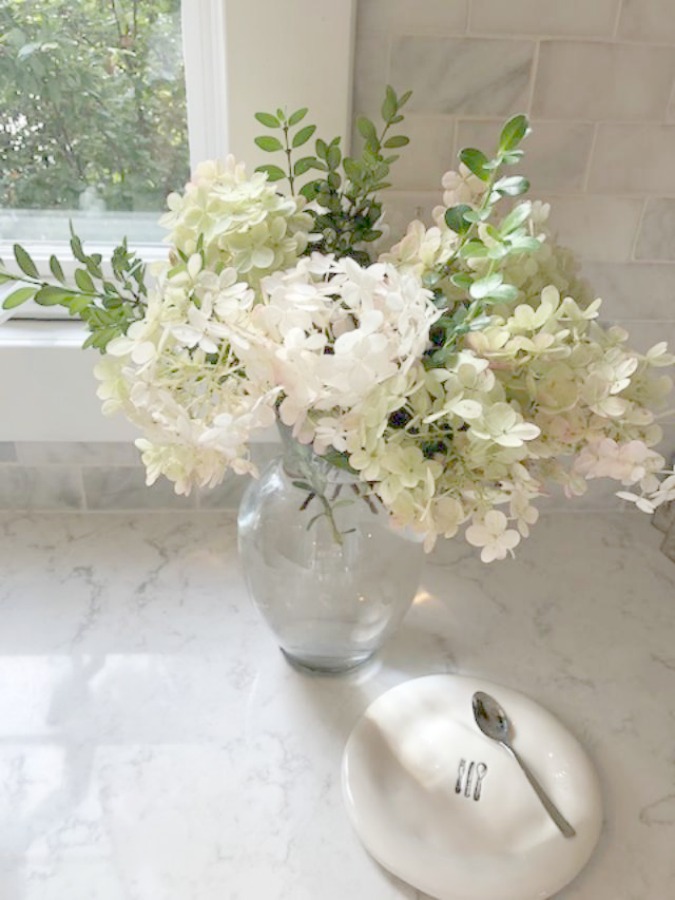 A mix of whites in my timelessly tranquil kitchen with European country decor, Viatera Minuet quartz, and Belgian linen - Hello Lovely Studio.