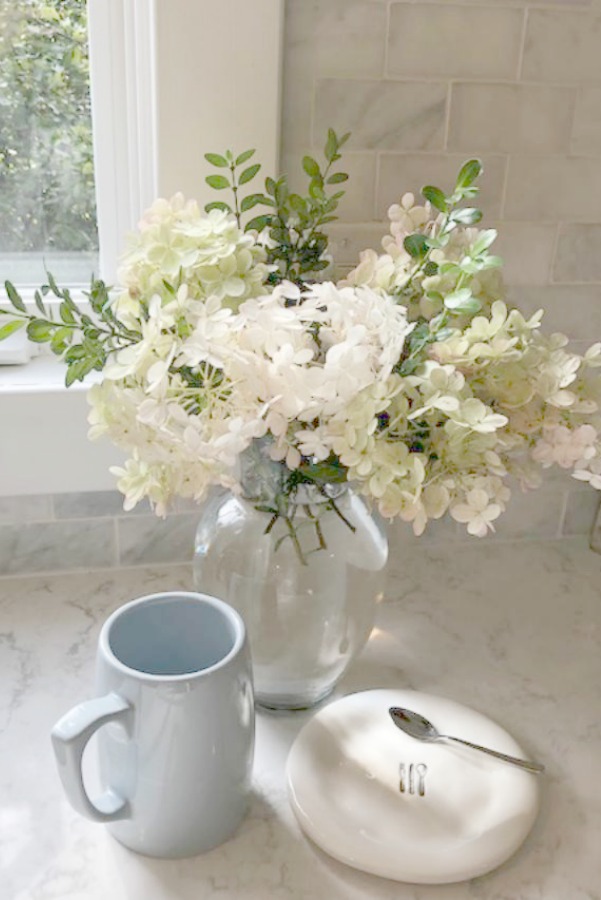 A mix of whites in my timelessly tranquil kitchen with European country decor, Viatera Minuet quartz, and Belgian linen - Hello Lovely Studio.