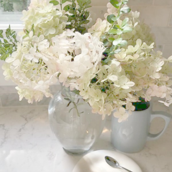 A mix of whites in my timelessly tranquil kitchen with European country decor, Viatera Minuet quartz, and Belgian linen - Hello Lovely Studio.