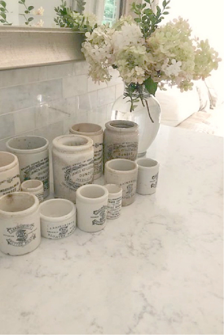 My white kitchen with Viatera Minuet quartz and collection of vintage Dundee marmalade jars - Hello Lovely Studio.