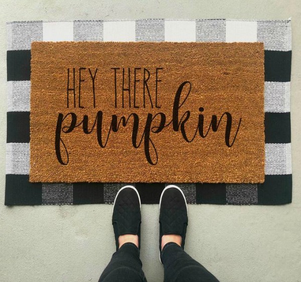 Layered doormat with "Hey There Pumpkin" mat over a black and white buffalo check rug...fall front door magic!