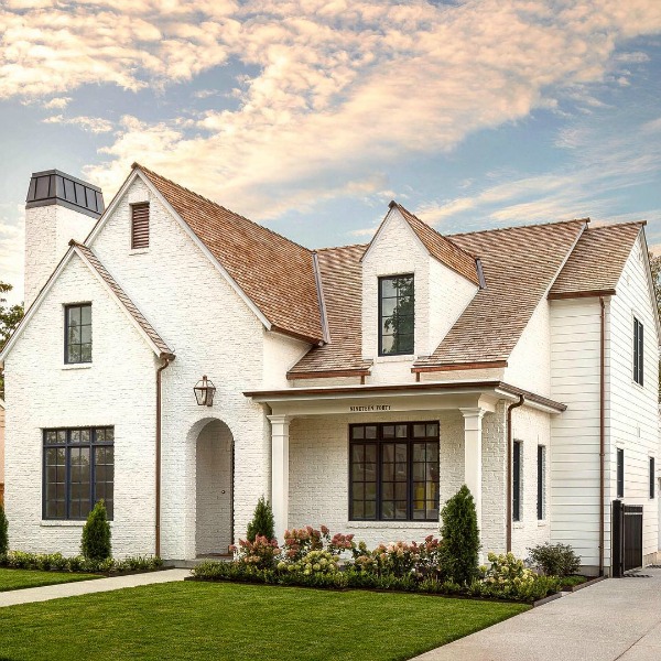 White painted brick exterior of Modern Tudor home by The Fox Group. Click through for 9 Tranquil, Traditional, Timeless Interior Design Ideas & Inspiring House Exteriors: The Fox Group!