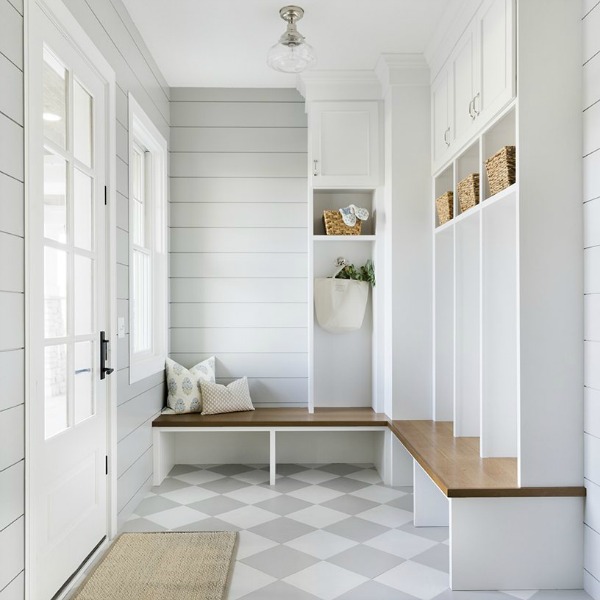 Serene and beautiful mud room with light grey and white check floor, shiplap, and custom built-ins with design by Bria Hammel.