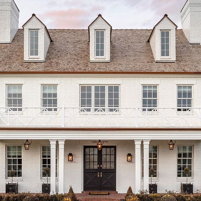 Breathtaking traditional white home exterior of new build by The Fox Group with dormers and double door entry.