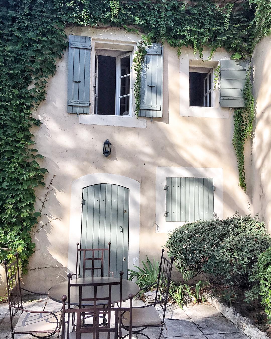 Charming and rustic French farmhouse exterior with Vert Olivier Green Shutters - photo by Vivi et Margot.