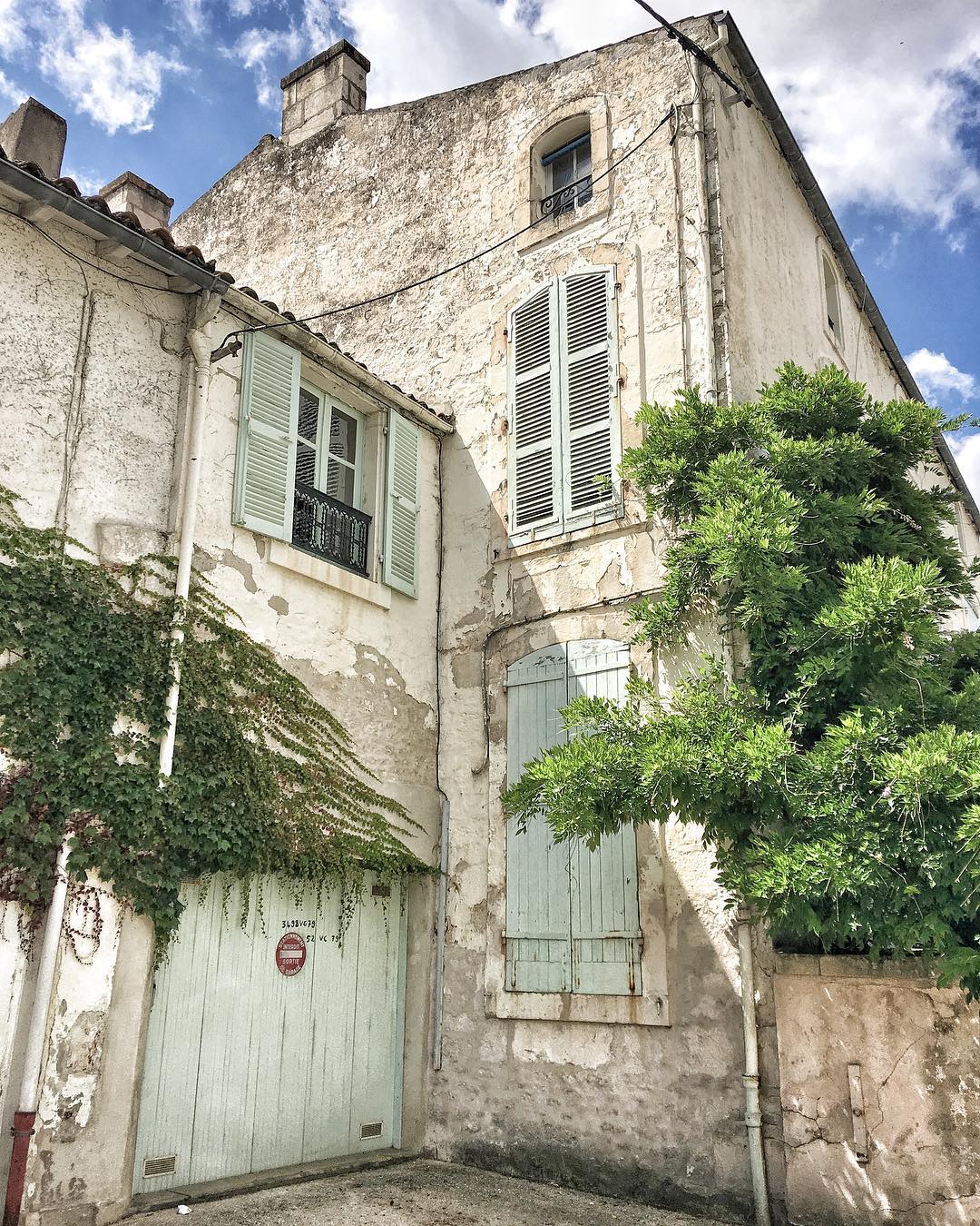 Charming and rustic French farmhouse exterior with Vert Olivier Green Shutters - photo by Vivi et Margot.