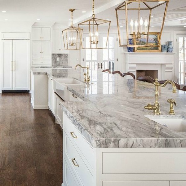 Elegant timeless kitchen with marble countertop and brass lantern island pendants - design by The Fox Group. Click through for 9 Tranquil, Traditional, Timeless Interior Design Ideas & Inspiring House Exteriors: The Fox Group!