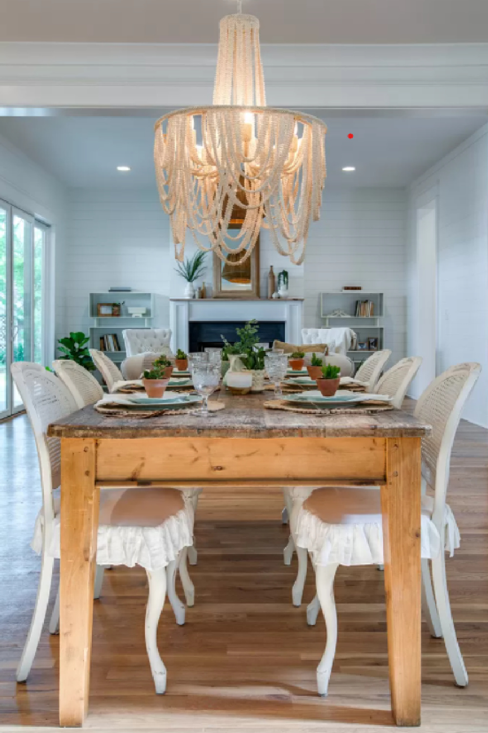 Country French farmhouse dining area with rustic farm table and cane back Louis style chairs in a Tennessee cottage in Franklin.