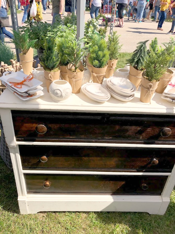 Greenery on a vintage dresser. Come discover rustic fall decorating ideas in this photo gallery with ideas and resources! 
 Vintage style, farmhouse decor, and junkin paradise in the fall - Main Street Market (Urban Farmgirl) in Belvidere, IL - Hello Lovely Studio. #fleamarket #vintage #farmhouse #countrydecor #midwest