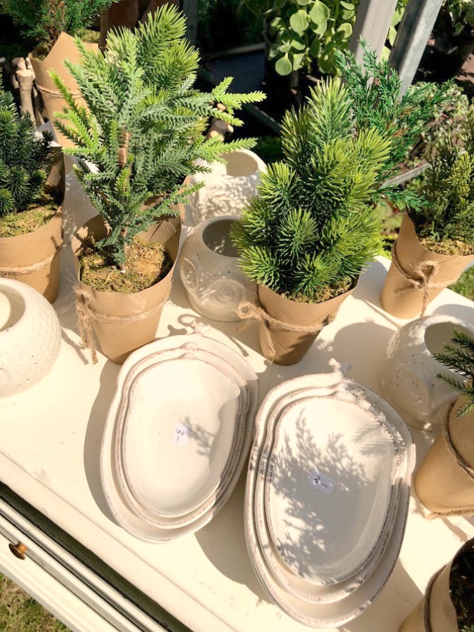 Greenery and white dishware. Come discover rustic fall decorating ideas in this photo gallery with ideas and resources! 
 Vintage style, farmhouse decor, and junkin paradise in the fall - Main Street Market (Urban Farmgirl) in Belvidere, IL - Hello Lovely Studio. #fleamarket #vintage #farmhouse #countrydecor #midwest