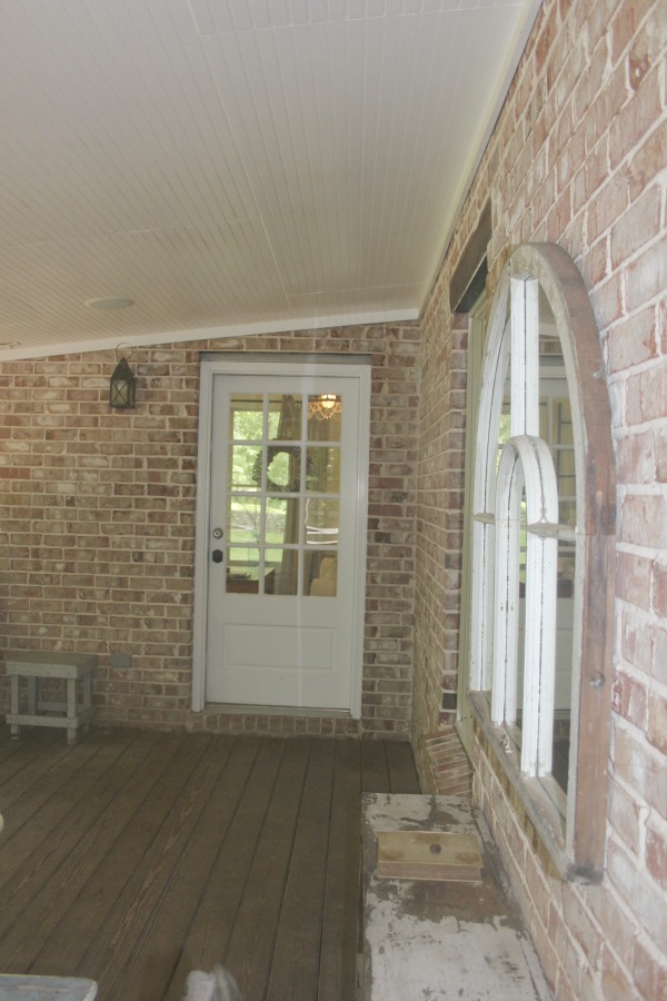 Screened porch in a rustic farmhouse style Storybook Cottage near Franklin, TN - Hello Lovely Studio. #porch #storybookcottage #farmhousestyle