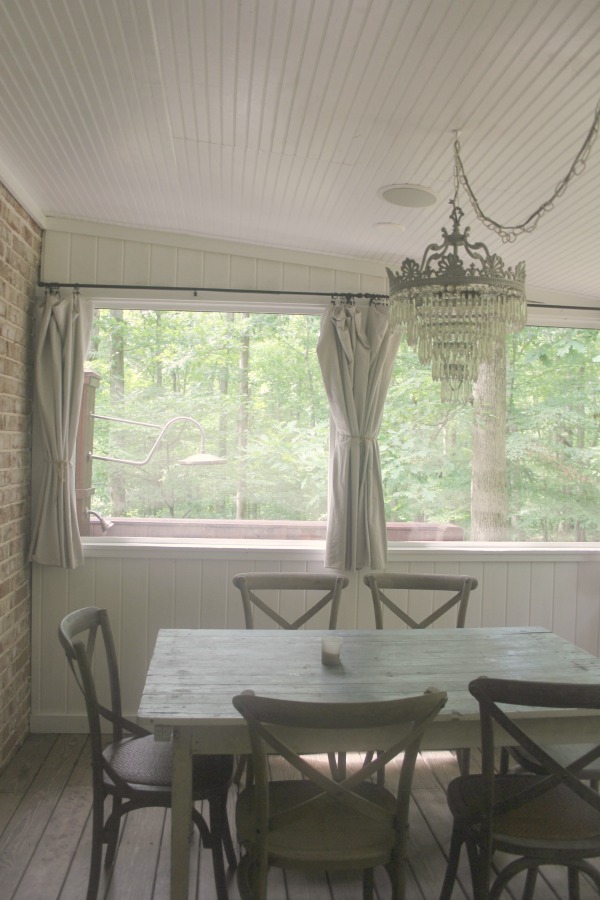 Screened porch in a rustic farmhouse style Storybook Cottage near Franklin, TN - Hello Lovely Studio. #porch #storybookcottage #farmhousestyle