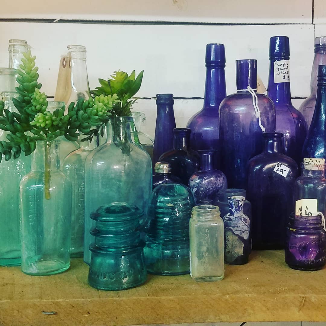 A collection of antique colorful bottles at Scarlett Scales Antiques. CLICK OVER to my place to discover 4 Charming Franklin Tennessee Shops for Vintage, Antiques & Farmhouse Decor Finds!