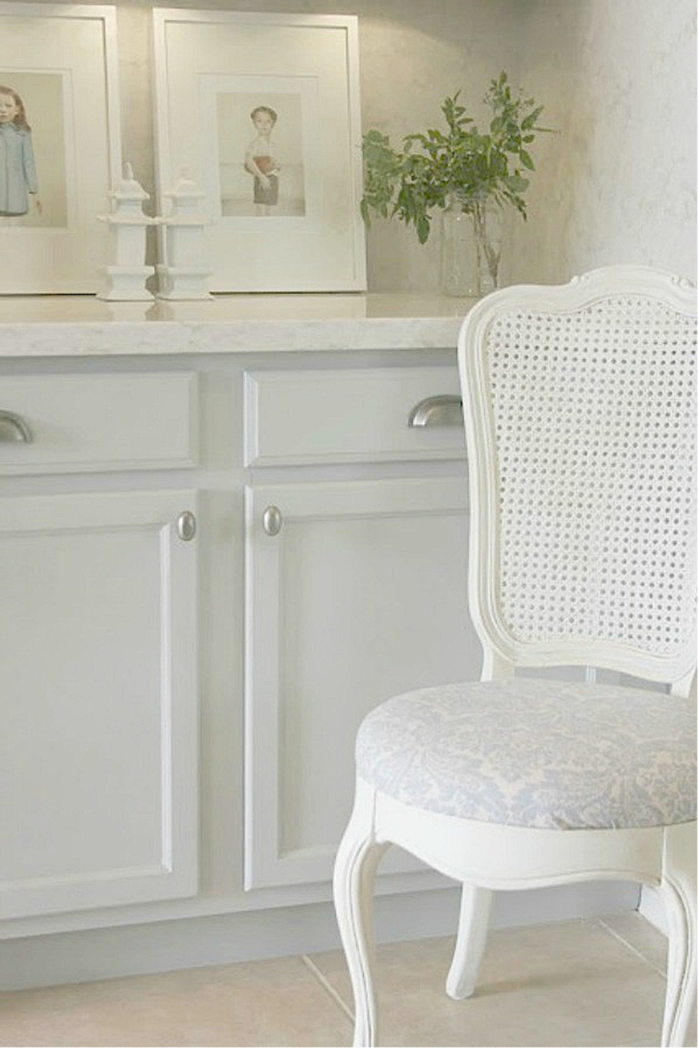 Behr Classic Silver paint color on kitchen cabinets in Hello Lovely's serene kitchen makeover with Viatera Soprano quartz. #hellolovelystudio #kitchendesign #paintcolors #behrclassicsilver #viaterasoprano #quartzcountertop #quartzbacksplash #kitchenaidappliances