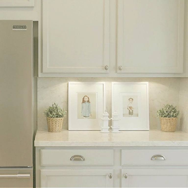 Behr Classic Silver paint color on kitchen cabinets in Hello Lovely's serene kitchen makeover with Viatera Soprano quartz. #hellolovelystudio #kitchendesign #paintcolors #behrclassicsilver #viaterasoprano #quartzcountertop #quartzbacksplash #kitchenaidappliances