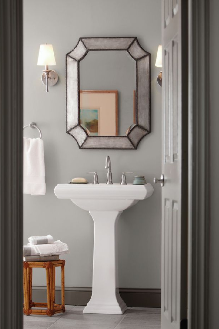 Behr Silver Bullet paint color is a lovely timeless hue in a powder bath with pedestal sink. #behrpaints #paintcolors #behrsilverbullet