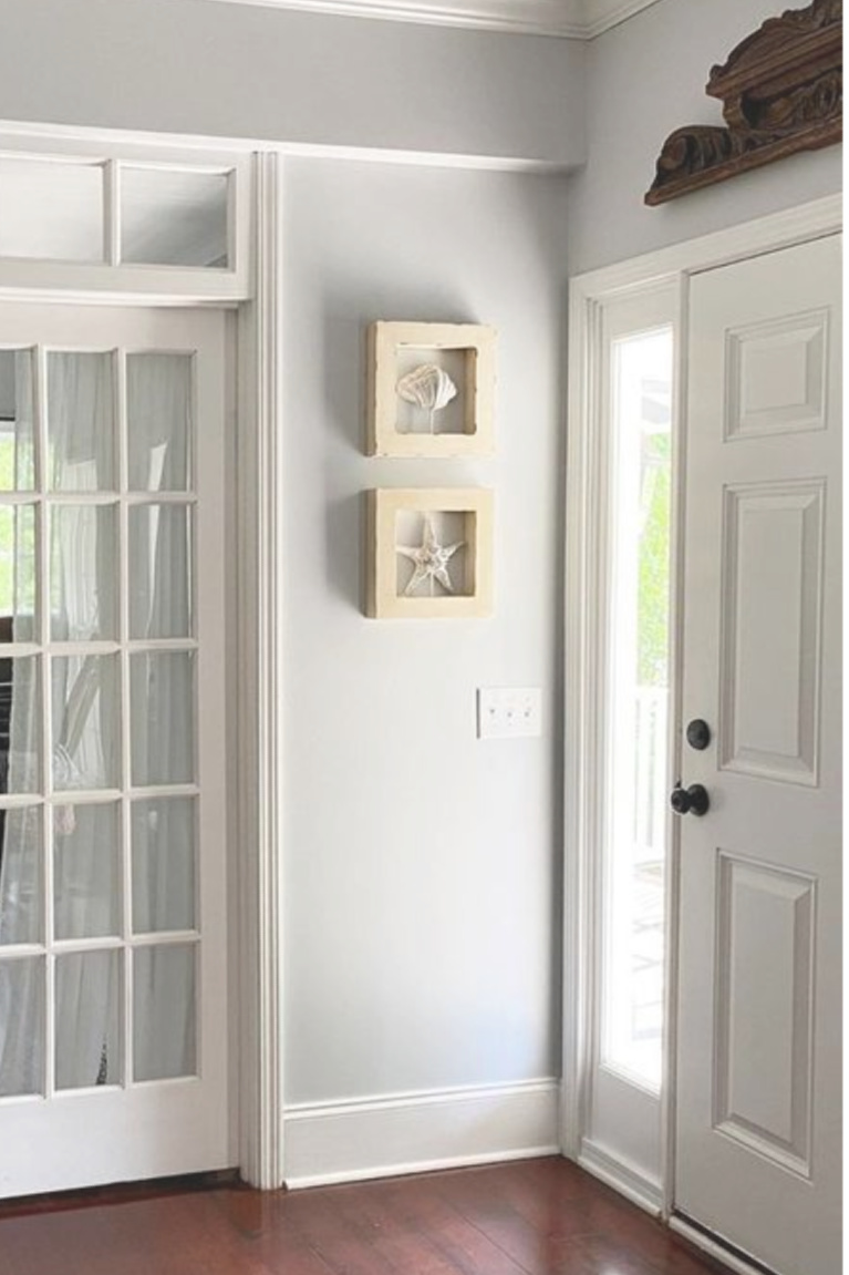 Entry walls are painted Behr Sterling (a light grey with blue undertones) and paired with white moldings - This Girl Paints. #behrsterling #lightgrey #paintcolors #greypaint