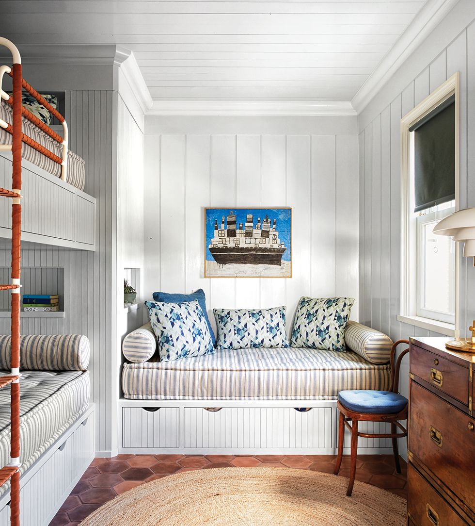 Shiplap and custom cushions in a coastal style bunk room with built-ins and blue accents is a delightful design by Tom Scheerer, photo by Francesco Lagnese. Elle Decor.