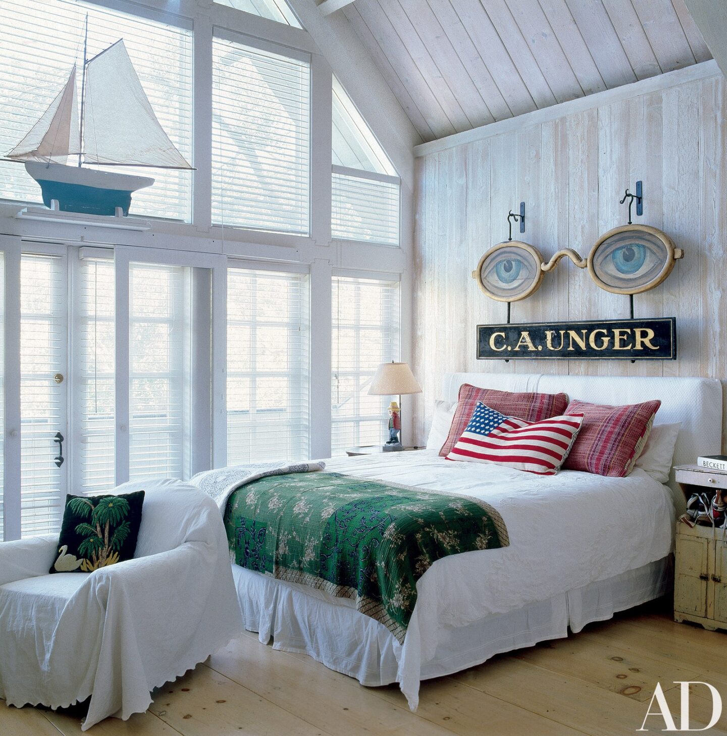 Lofty farmhouse rustic bedroom with white planked walls in the LA home of Malcolm McDowell. Photo by Miguel Flores-Vianna for Architectural Digest. Timeless Tastemaker Trifecta: Lisa Fine, Tom Scheerer and Miguel Flores-Vianna...in case you admire sophisticated design.