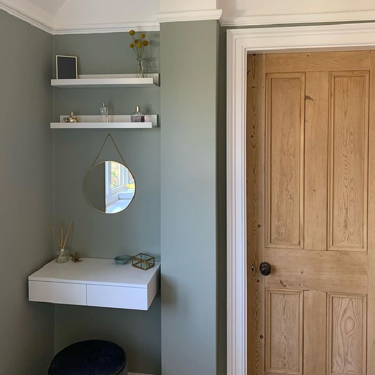Farrow & Ball French Gray paint color on walls of a beautiful dressing area with white shelves and natural wood paneled door - Edwardian Semi Northwest. #farrowandball #bluegray #paintcolors #graypaints #bluegreypaint
