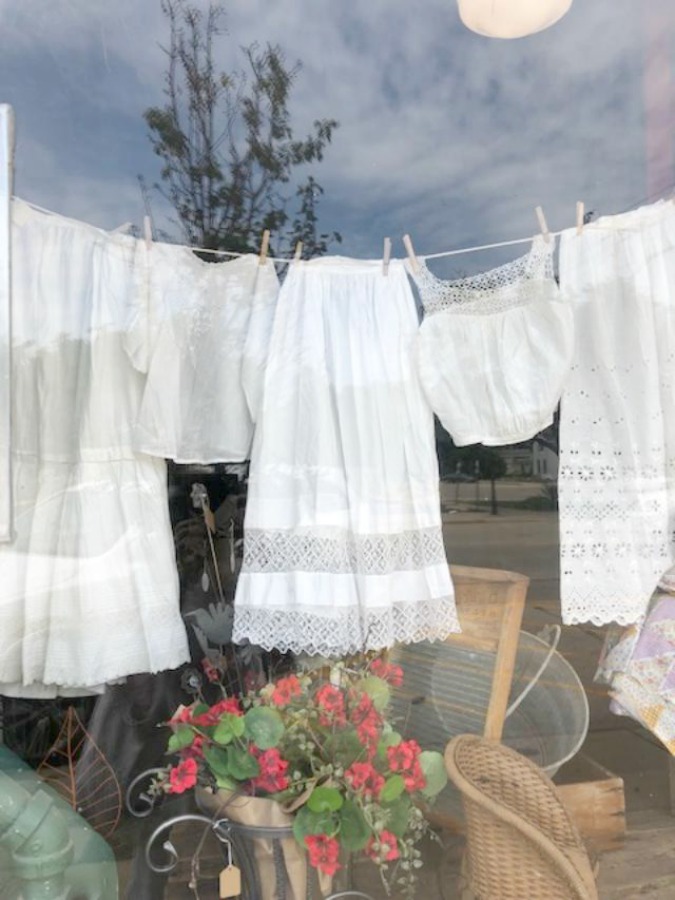 Charming clothesline in a shop window! Rustic farmhouse decor, vintage flea market treasures, and LOVELY Fall and Autumn inspiration are flowing as I take you shopping with me for country goodness in the Northern Illinois and Southern Wisconsin. Hello Lovely Studio. #farmhousestyle #rusticdecor #countryhomes #fleamarket