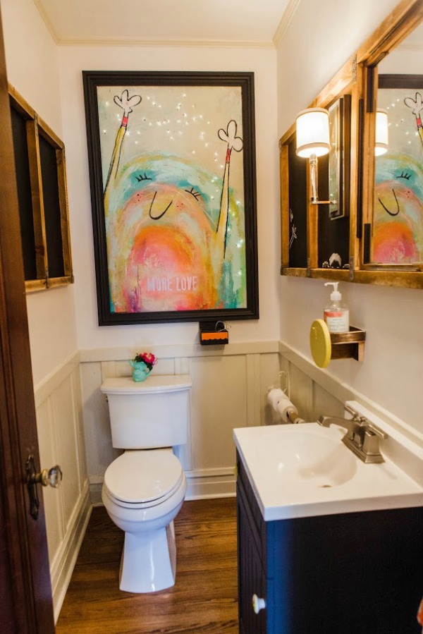 Electric powder room! Be inspired by this photo gallery of vibrant colorful beachy boho interior design from artist Jenny Sweeney's Chicagoland home. Her art has been lifting spirits and opening hearts to wonder - see how it lives large in a charming suburban Tudor!