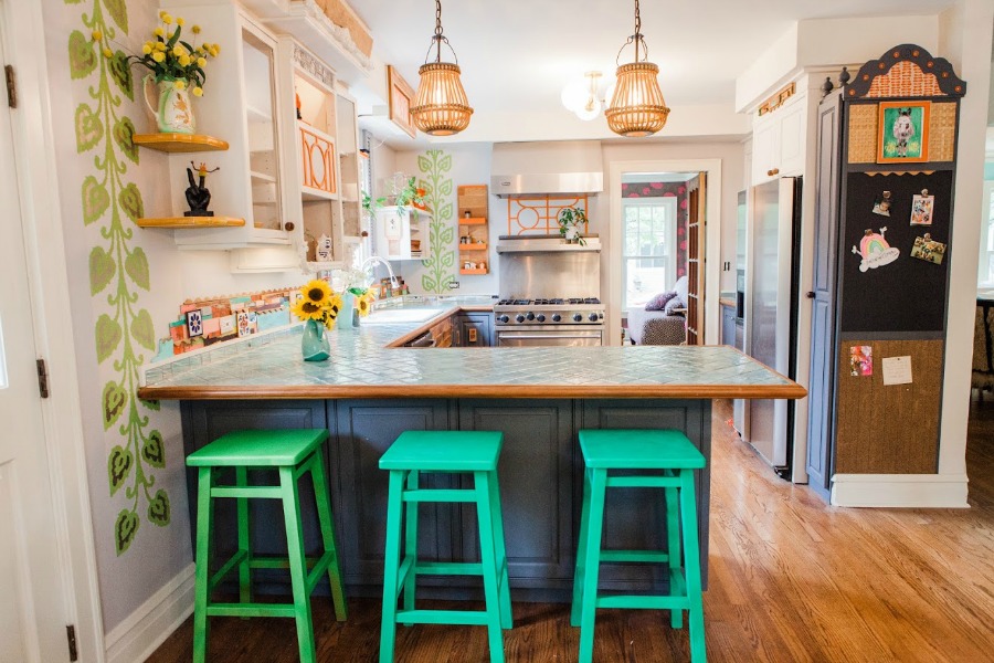 Bright green kitchen stools. Be inspired by this photo gallery of vibrant colorful beachy boho interior design from artist Jenny Sweeney's Chicagoland home. Her art has been lifting spirits and opening hearts to wonder - see how it lives large in a charming suburban Tudor!