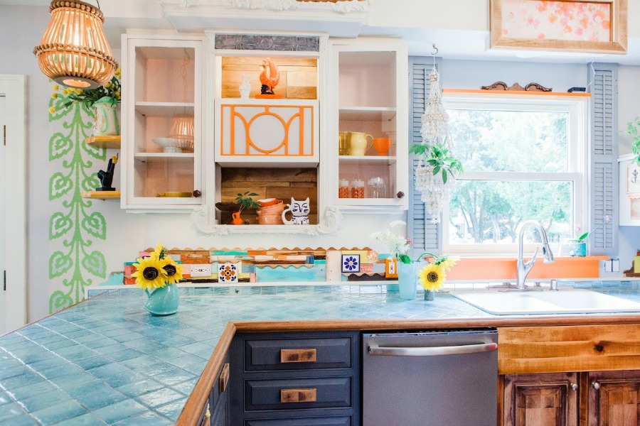 Turquoise, orange, and spring green in a kitchen. Be inspired by this photo gallery of vibrant colorful beachy boho interior design from artist Jenny Sweeney's Chicagoland home. Her art has been lifting spirits and opening hearts to wonder - see how it lives large in a charming suburban Tudor!