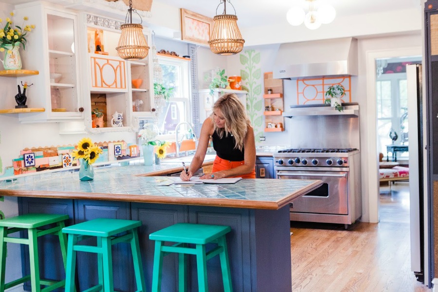 Be inspired by this photo gallery of vibrant colorful beachy boho interior design from artist Jenny Sweeney's Chicagoland home. Her art has been lifting spirits and opening hearts to wonder - see how it lives large in a charming suburban Tudor! #bohemian #interiordesign #colorful