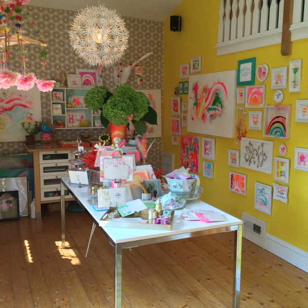 Electric yellow walls of studio. Be inspired by this photo gallery of vibrant colorful beachy boho interior design from artist Jenny Sweeney's Chicagoland home. Her art has been lifting spirits and opening hearts to wonder - see how it lives large in a charming suburban Tudor!