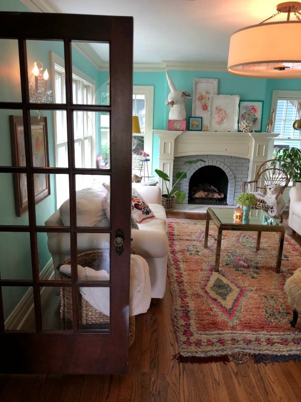 Turquoise walls in living room. Be inspired by this photo gallery of vibrant colorful beachy boho interior design from artist Jenny Sweeney's Chicagoland home. Her art has been lifting spirits and opening hearts to wonder - see how it lives large in a charming suburban Tudor!