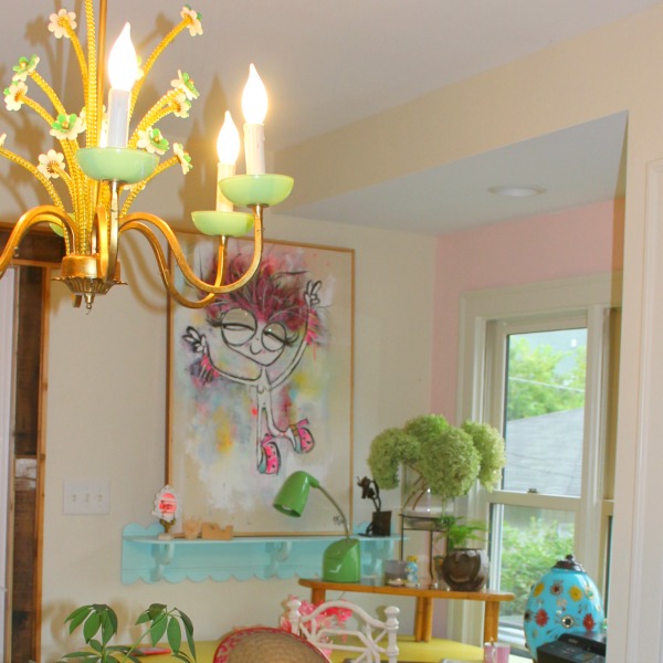 Colorful, cheerful, beachy boho office area with vintage chandelier and art by Jenny Sweeney. #colorfuldecor #pinkwalls #interiordesign #vintagestyle #bohochic