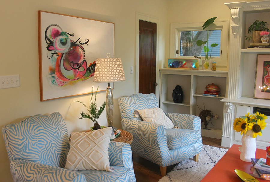 Colorful den in an eclectic beachy boho cottage by Jenny Sweeney. #interiordesign #colorfuldecor #boho #beachy #vintagestyle