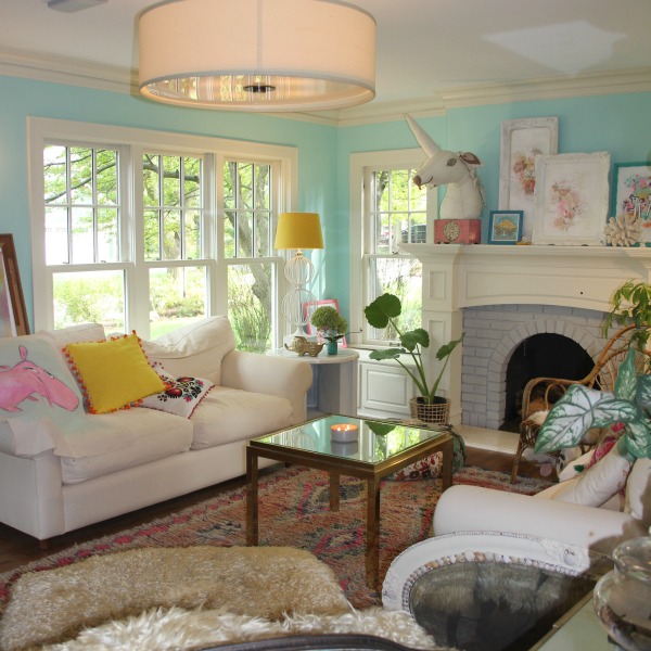 Colorful living room painted a bright cheerful turquoise blue - design by Jenny Sweeney. Time to Paint Your Walls? Come discover a Refresher to Demystify the Process!