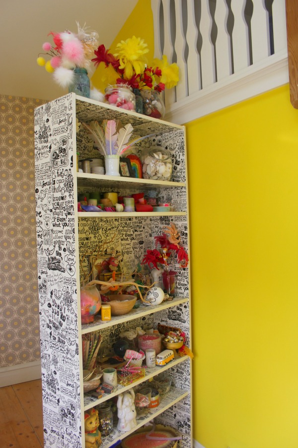 Neon yellow walls in the cheerful and eclectic colorful studio of Jenny Sweeney.