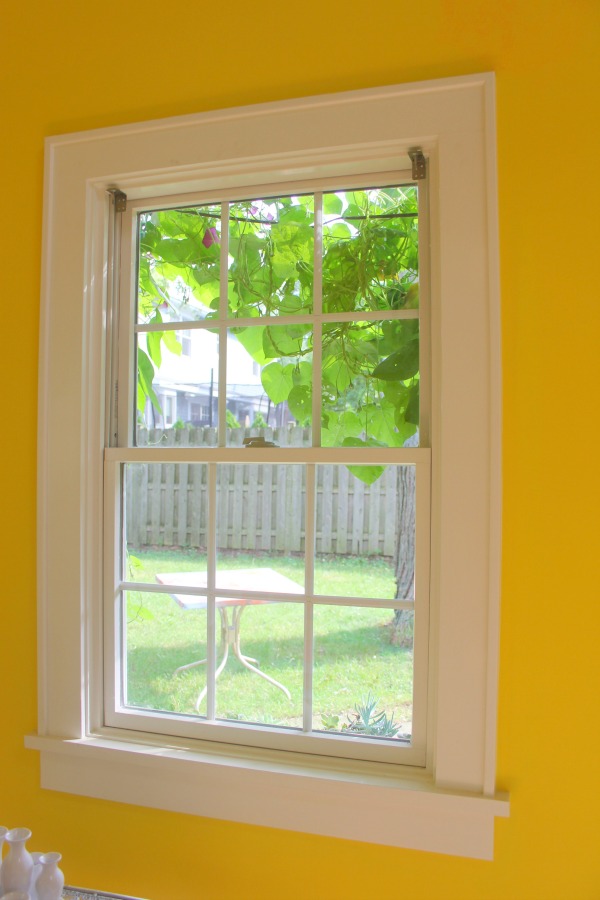 Neon yellow walls in the cheerful and eclectic colorful studio of Jenny Sweeney.