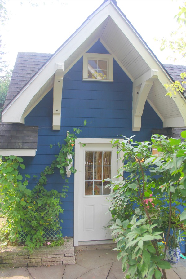 Vibrant blue exterior of the artist studio (climbing with ivy!) of Jenny Sweeney in Libertyville, IL. #cottage #colorfuldesign #climbingvines