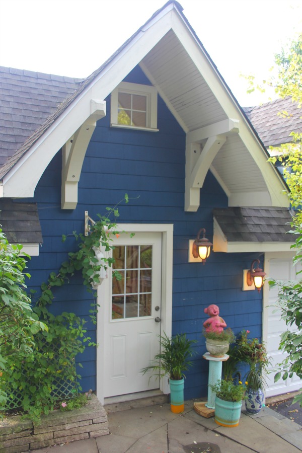 Vibrant blue exterior of the artist studio (climbing with ivy!) of Jenny Sweeney in Libertyville, IL. #cottage #colorfuldesign #climbingvines