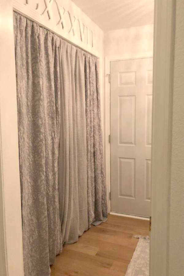 Come see how I made our awful little pass through laundry room next to the garage function better and look peaceful with simple inexpensive DIY - Hello Lovely Studio. #beforeafter #laundryroom #diy #makeover #serenedecor