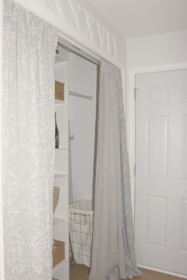 Come see how I made our awful little pass through laundry room next to the garage function better and look peaceful with simple inexpensive DIY - Hello Lovely Studio. #beforeafter #laundryroom #diy #makeover #serenedecor