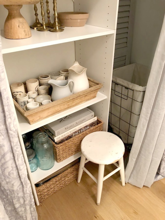 Come see how I made our awful little pass through laundry room next to the garage function better and look peaceful with simple inexpensive DIY - Hello Lovely Studio. #beforeafter #laundryroom #diy #makeover #serenedecor