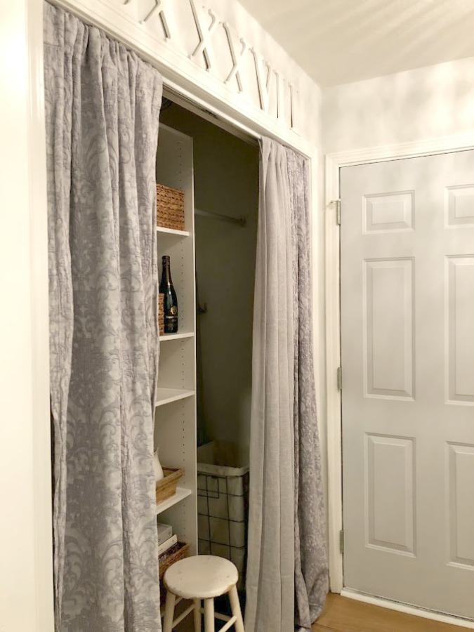 Come see how I made our awful little pass through laundry room next to the garage function better and look peaceful with simple inexpensive DIY - Hello Lovely Studio. #beforeafter #laundryroom #diy #makeover #serenedecor