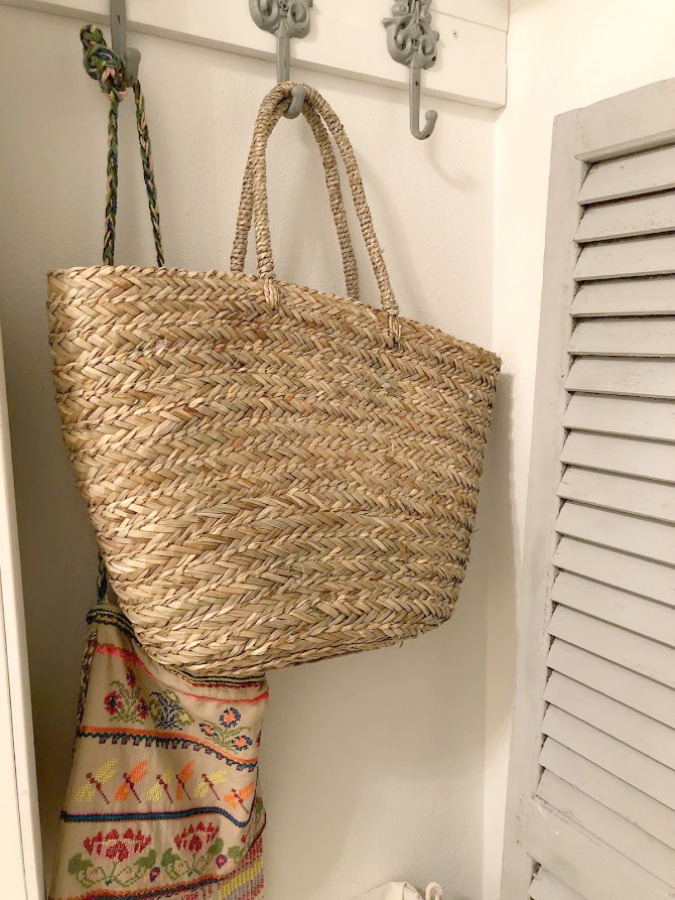Come see how I made our awful little pass through laundry room next to the garage function better and look peaceful with simple inexpensive DIY - Hello Lovely Studio. #beforeafter #laundryroom #diy #makeover #serenedecor